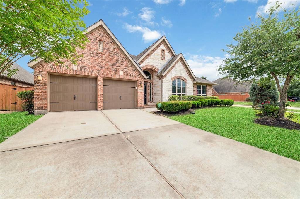 Desirable corner lot property with a spacious double-wide driveway, offering extra parking and convenient access