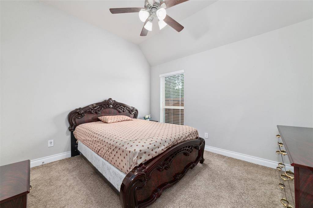 Third bedroom in the home with ceiling fan and walk in closet