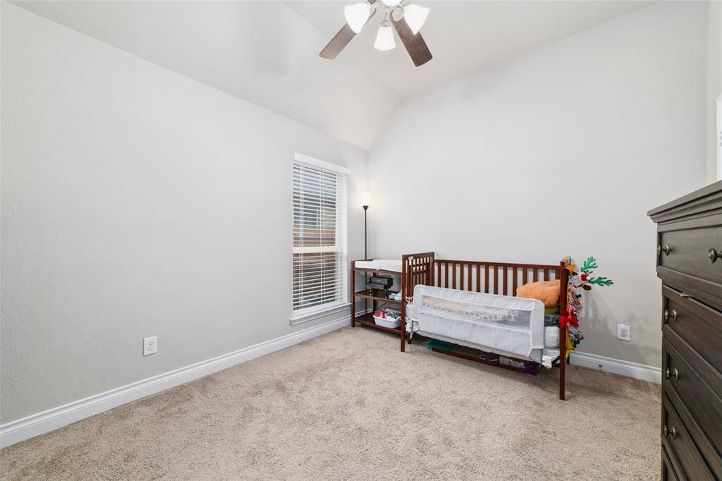 Spacious fourth bedroom featuring a ceiling fan and a deep walk-in closet—perfectly suited as a nursery, guest room, or flexible space to fit your needs