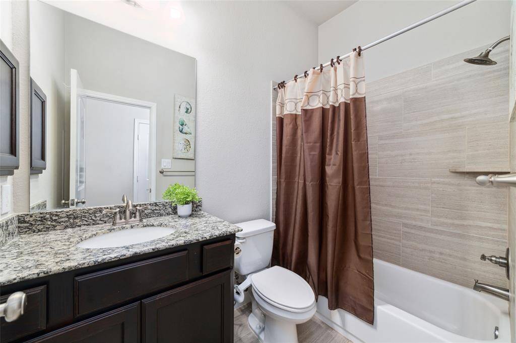 The second of three full bathrooms, this space offers a tub/shower combination and upgraded granite countertops for a stylish and functional finish