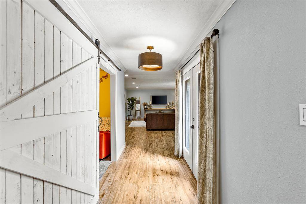Hallway leading to secondary living area and primary bedroom.