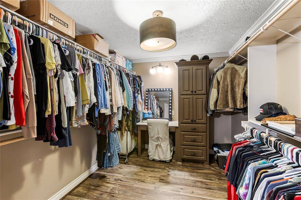 HUGE custom closet complete with builtin vanity area and lighting!