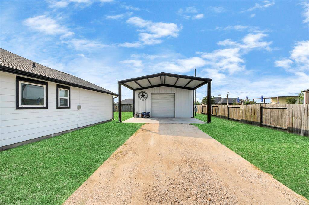 Gravel driveway leading to shop