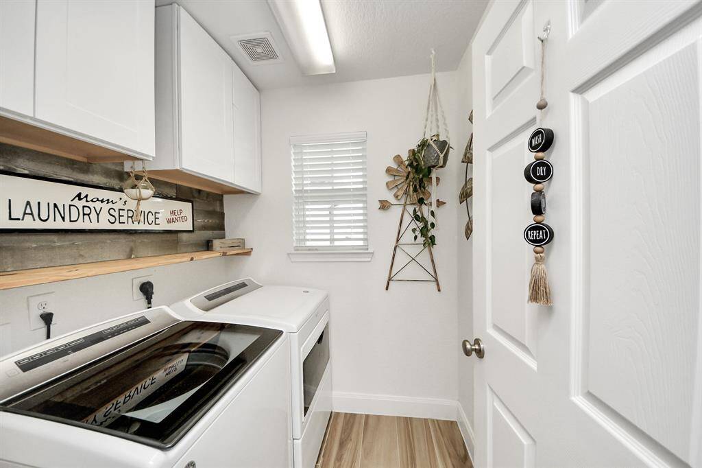 Laundry room with abundant storage and natural light
