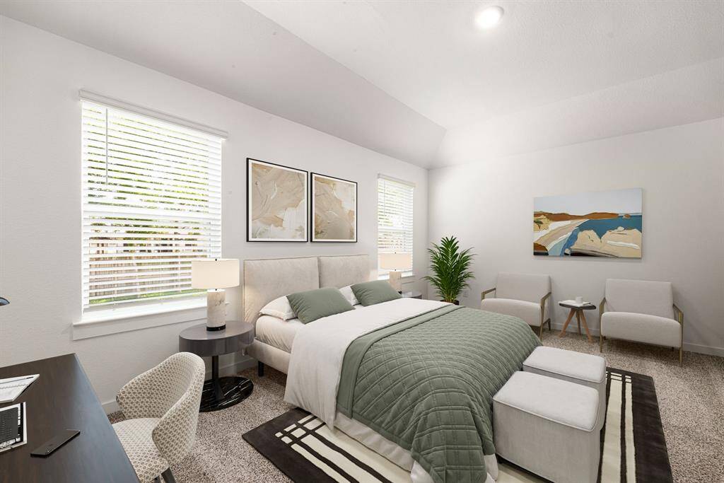 This spacious and light-filled bedroom offers a serene retreat with soft neutral tones, plush carpeting, and large windows that bring in an abundance of natural light. High ceilings enhance the airy feel, while clean lines and tasteful wall accents create a modern, calming atmosphere. Ideal for restful living, this room is a perfect blend of comfort and contemporary style.