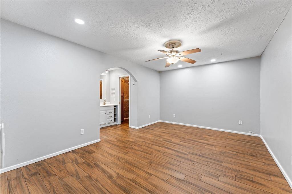 As you step inside, to the right you'll see a doorway that leads to a large laundry room as well as an added flex space or additional bedroom.