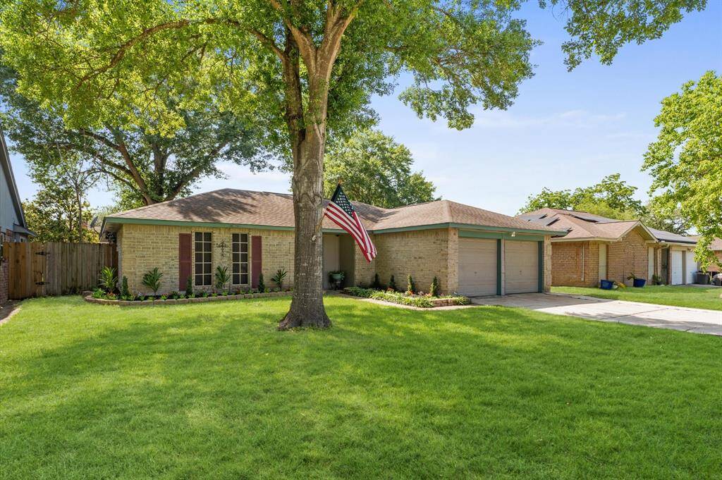 Front landscaping wraps around the front of the home creating great curb appeal. The front sidewalk is bordered by more landscaping as it leads to a covered entryway.