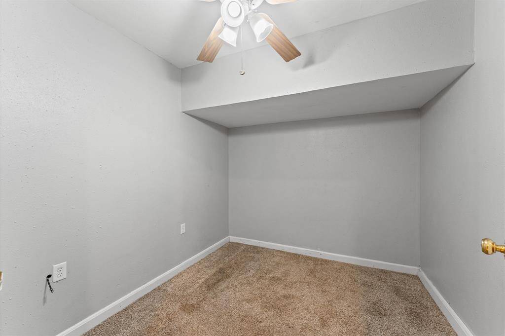 The door on the left opens to the living room, while the door at the far end is a private patio entrance from the primary suite.