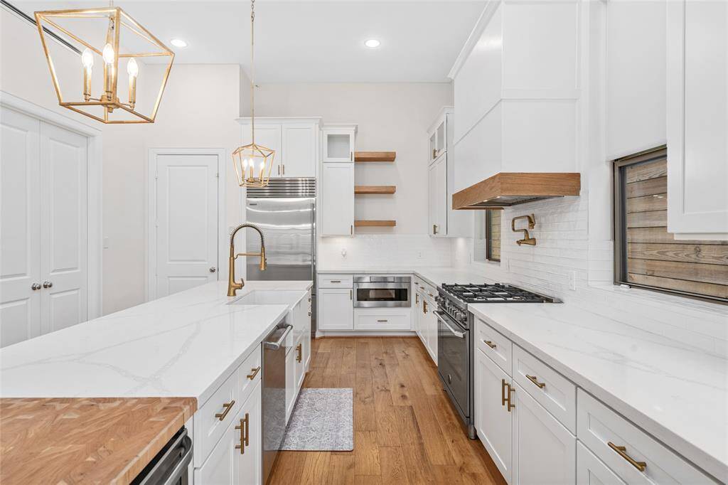 Stylish lighting fixtures and under cabinet lighting throughout the kitchen.