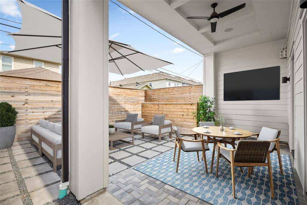 The covered patio has plenty of space to fit a dining set. *Virtual staging has been added*