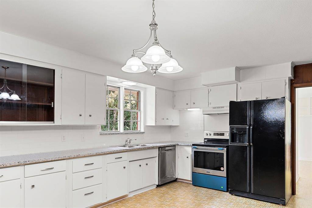 A closer view of the new granite, subway tile backsplash, stainless steel appliances. Double windows allow picturesque views of the back acreage.