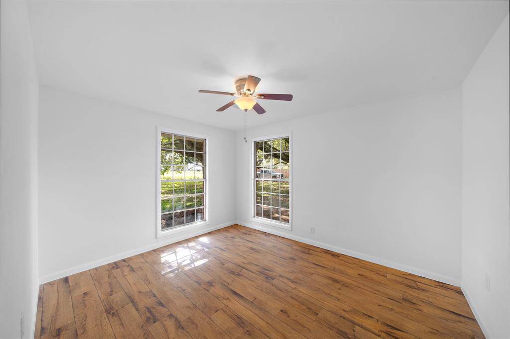 Second bedroom. Note the beautiful floors, new paint, new ceiling fan. All bedrooms are generously sized.