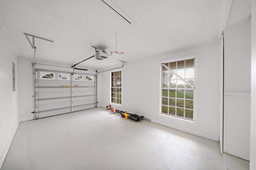 The garage with painted and sealed floor is heated and cooled by the central HVAC. This could easily be converted to another room.