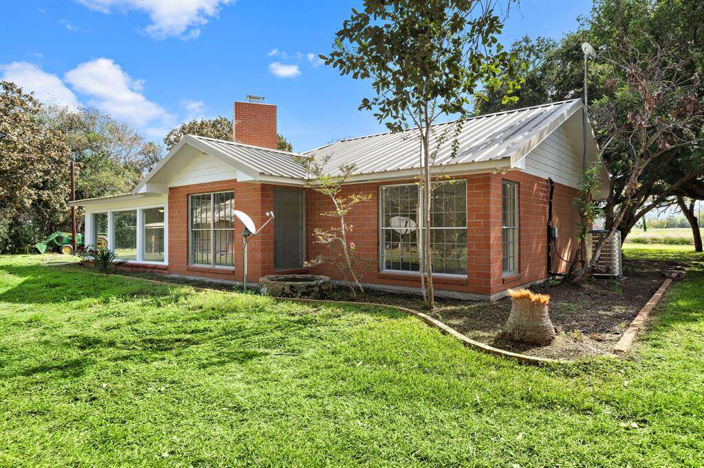Another view shows all the windows at the back of the home that provide views of the picturesque acreage.