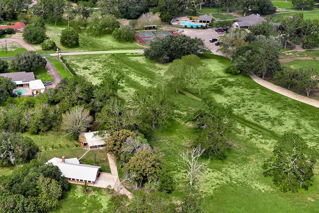 Aerial view of the home, guest house and acreage and the grounds of the Wharton Country Club and golf course.