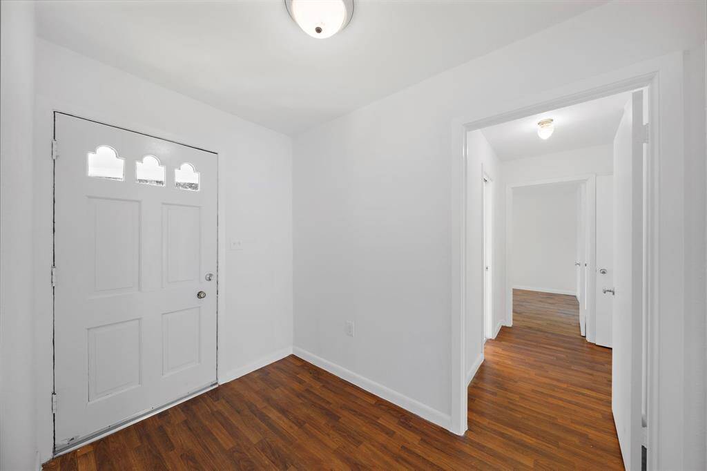 View of the hallway to the secondary bedrooms and full bath. The primary suite is located at the back of the home in this split floor plan.