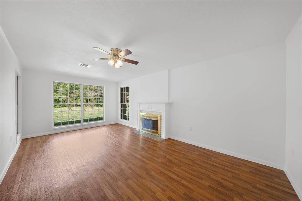One of THREE living areas in this beautiful home. One of TWO fireplaces. So much living space for entertaining guests or to  relax and spend quality time with your family.
