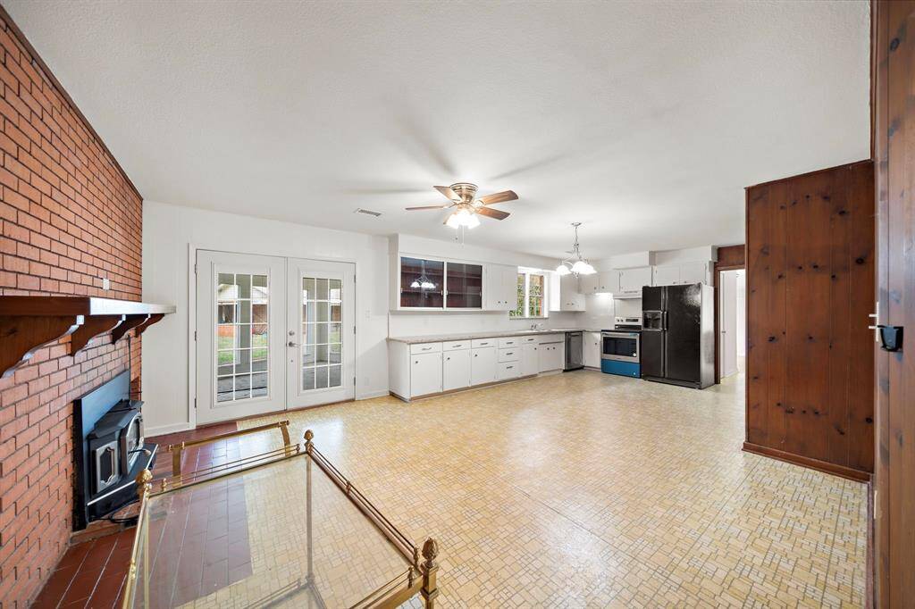 You will love the openness of the kitchen dining and one of 3 living areas in this beautiful home. Note the wood burning fireplace. French doors lead to the third living area.