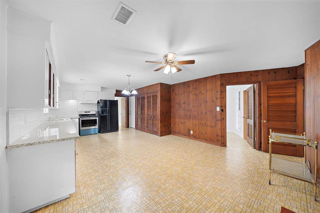 View of the expansive kitchen dining and living area. Room for a dining table and a seating area around the fireplace. Stay in touch with guests during meal prep time.