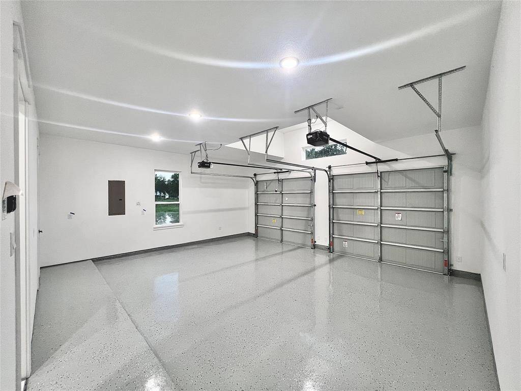 For those Electric Car Enthusiasts check out this Large 24'X 22'  Epoxy Garage Floors with EV CHARGING Station! (Builder Up-Grade), 10' Ft. Ceiling Height, Garage Door Openers and Tandem Window above Garage Doors, give this Garage a Gym-like feel plus a 8X4.5' Garage Storage Closet.
