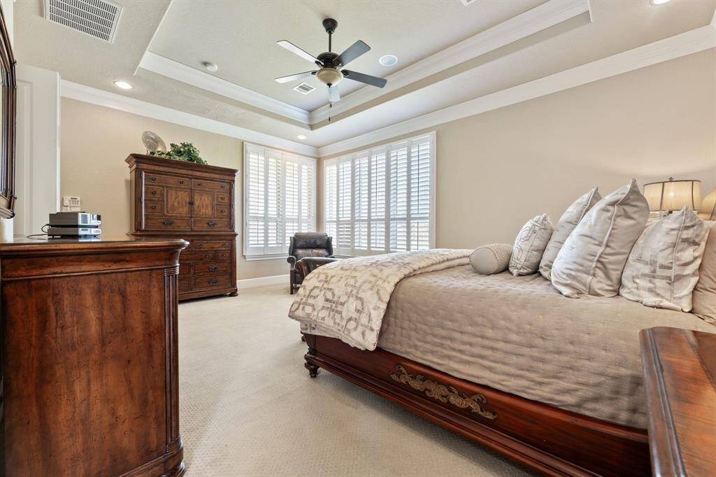 The primary bedroom’s generous proportions are highlighted in this view, emphasizing its spaciousness and tranquil ambiance.