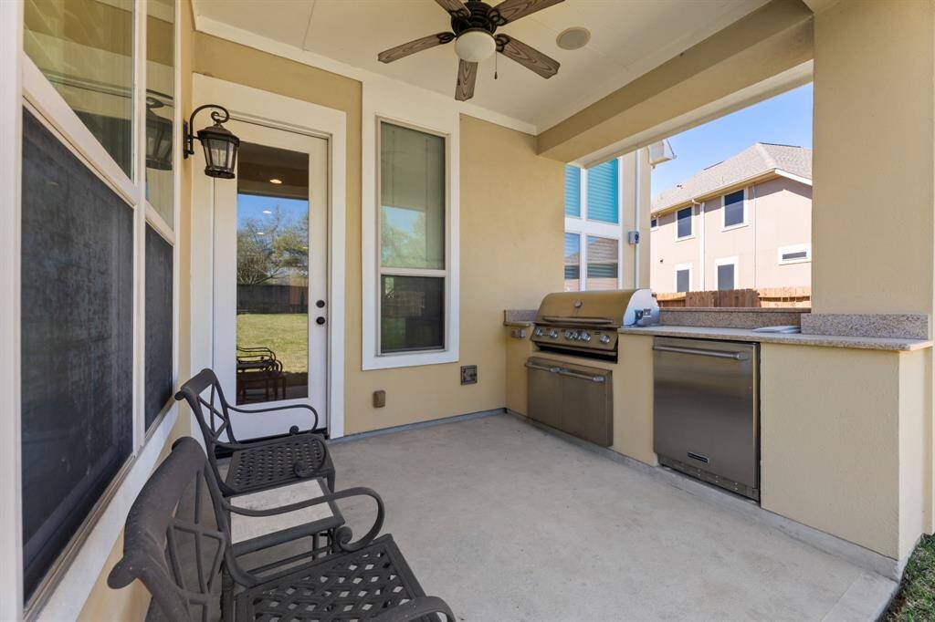 Equipped with a grill and ceiling fan, the patio is an ideal space for alfresco dining and entertaining.
