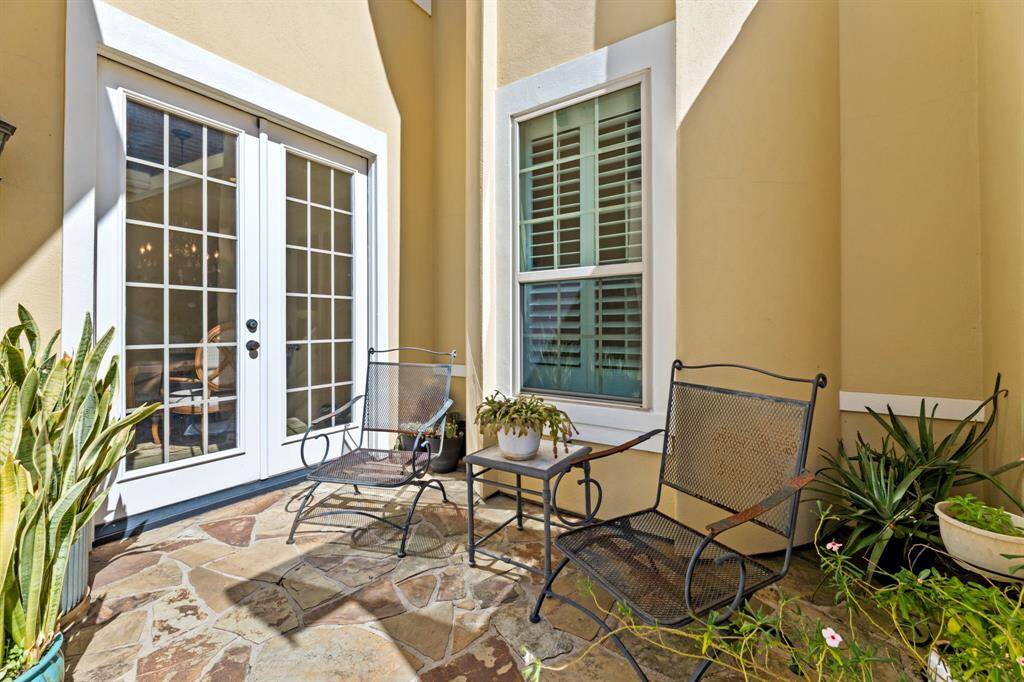 A tranquil spot just outside the formal dining room, accessible through elegant French double doors.
