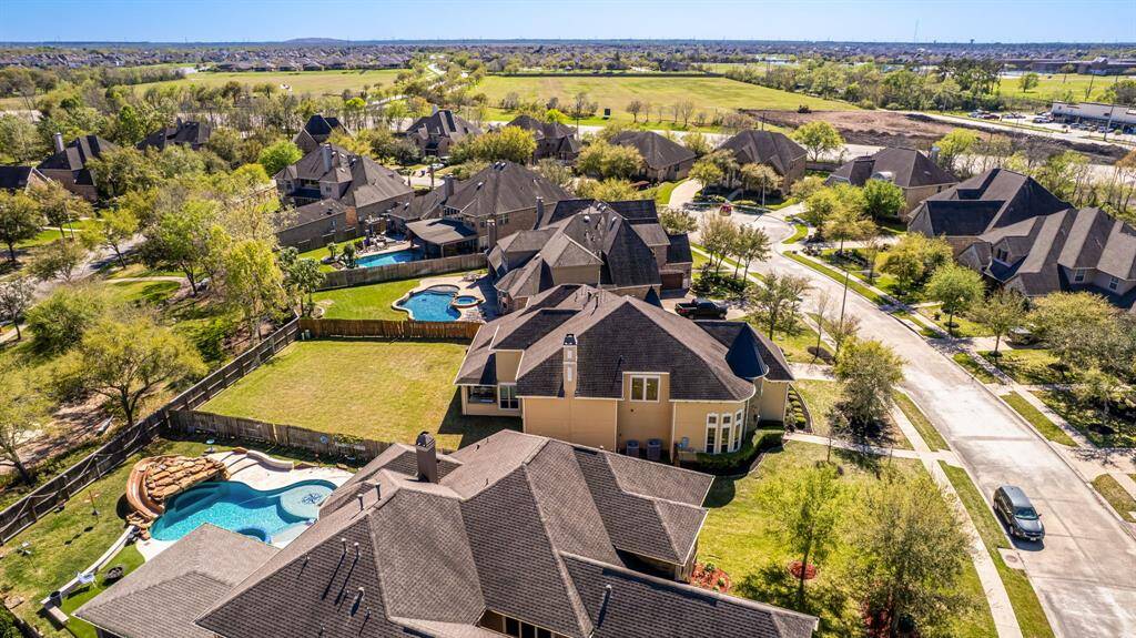This high-angle view showcases how seamlessly the property blends into its upscale neighborhood. The thoughtfully designed layout of nearby homes and green spaces enhances the appeal of this sought-after location.