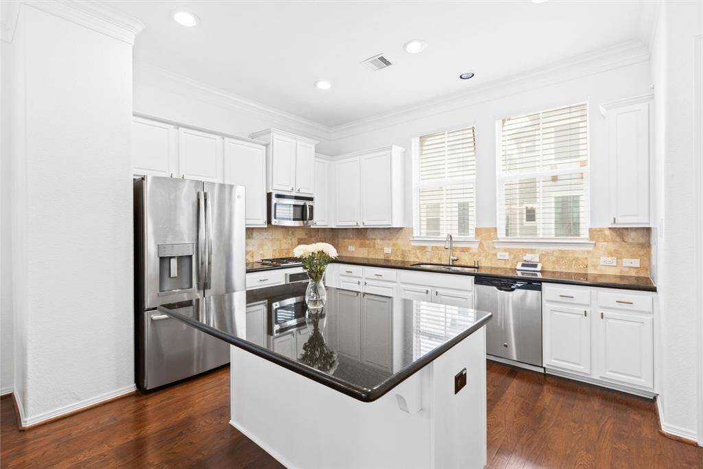 This kitchen has all the countertop space and storage you could need. The kitchen cabinets were repainted in 2024! Kitchen Refrigerator, Washer and Dryer stay with the home.