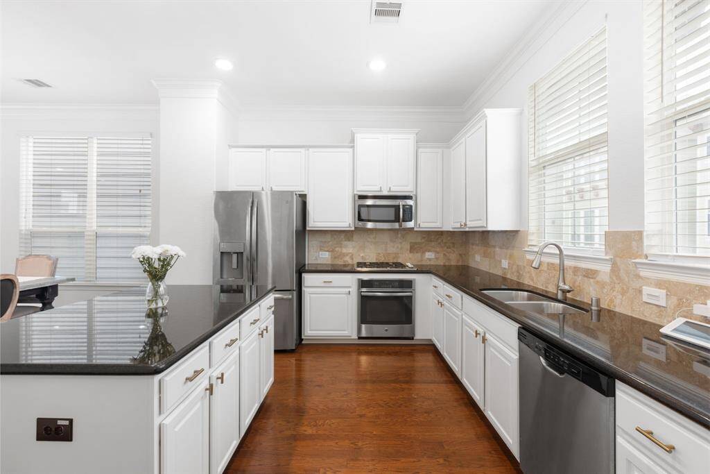 This kitchen has all the countertop space and storage you could need. The kitchen cabinets were repainted in 2024! Kitchen Refrigerator, Washer and Dryer stay with the home.
