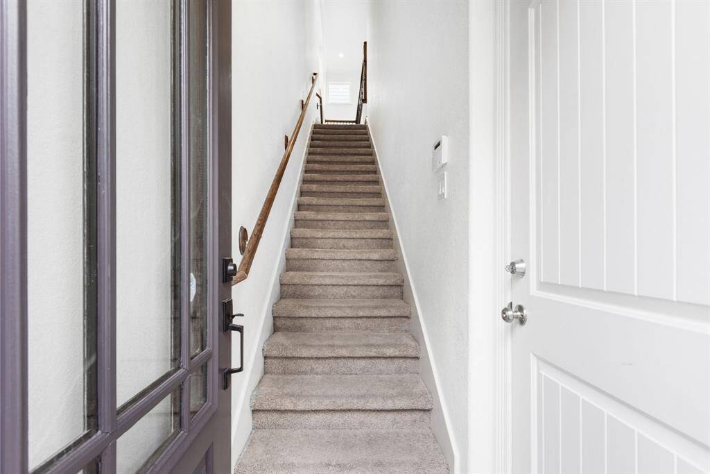 Upon entering you are greeted with a garage access point on your right, and the stairs to the main living room.