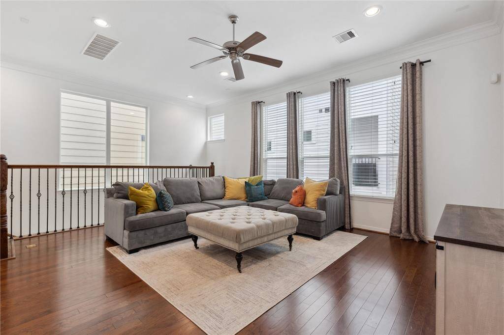 At the top of the stairs, you find your large main living space with tons of natural light and glowing hardwood floors. (All furniture is included if desired!)
