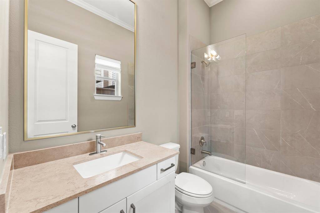 Spacious first-floor bathroom with ample counter space and a convenient tub/shower combo.