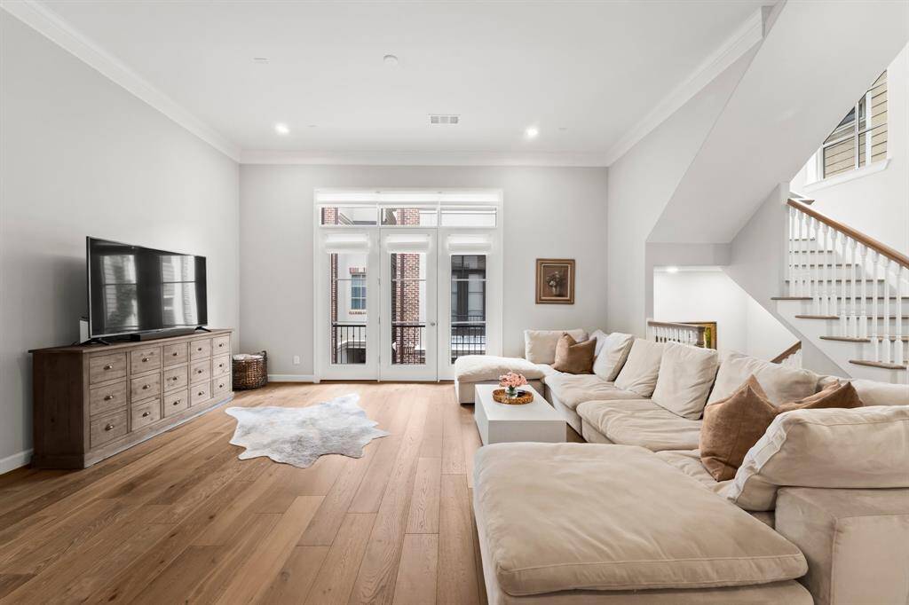 Spacious living room with ample space for large furniture, leading to a private balcony.