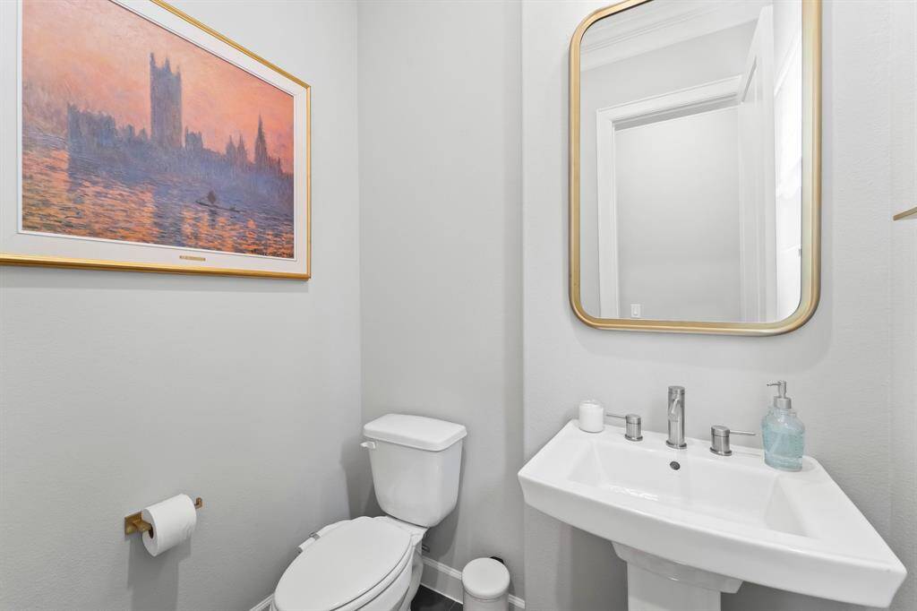 Elegant second-floor powder room with modern fixtures and tasteful decor.