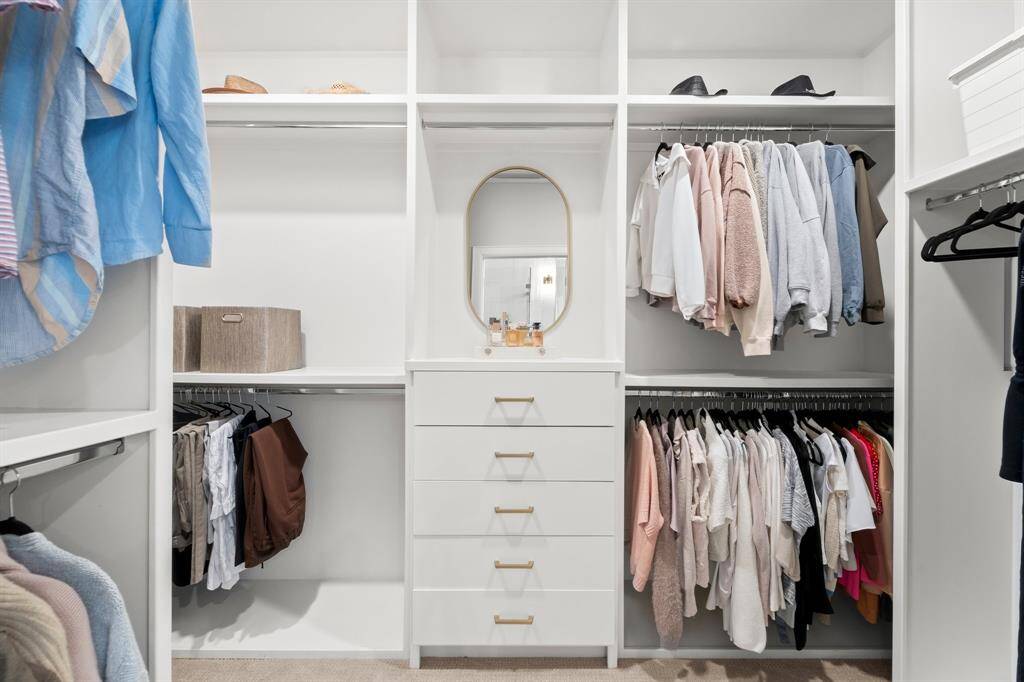 Spacious walk-in closet conveniently connected to the bathroom.