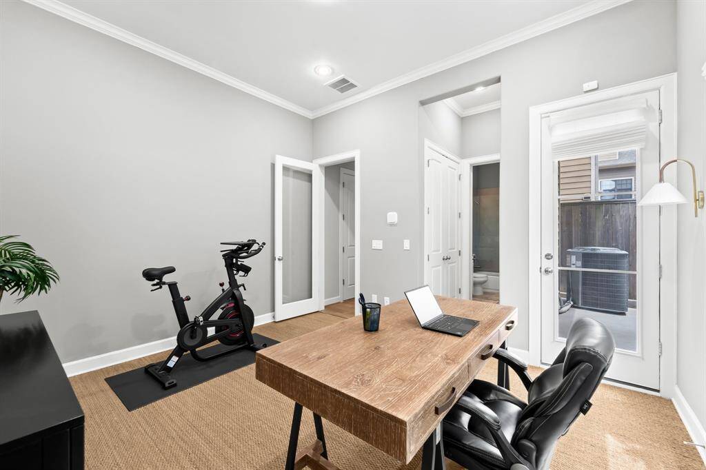 Experience comfort in the first-floor bedroom, featuring an ensuite bath, stylish sisal carpet, and a private terrace.