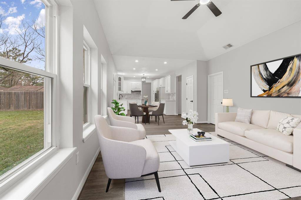 Virtually Staged: WOW! This family room is the perfect place to entertain family and friends as it offers a seamless, open floor plan. Easy access to your amazing kitchen and breakfast space! Large windows providing a beautiful view of the backyard, a ceiling fan, and vinyl plank floors that flows throughout the living space.