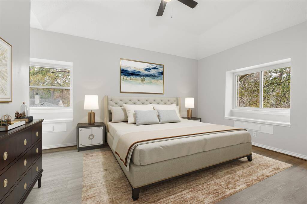 Virtually staged: A great place to rest after a long day! This magnificent master suite features vinyl plank floors, beautiful dark stained ceiling fan, and large windows!