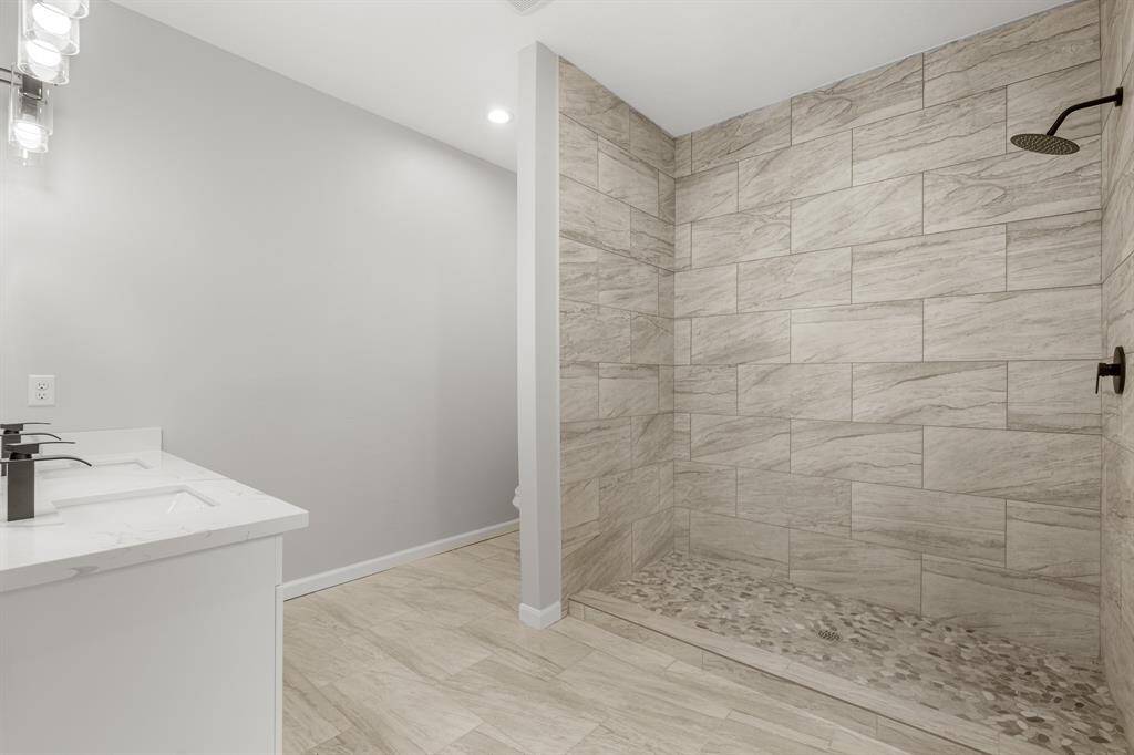Relax after a long day in this wonderful Primary Bathroom featuring tile flooring and recessed lighting.