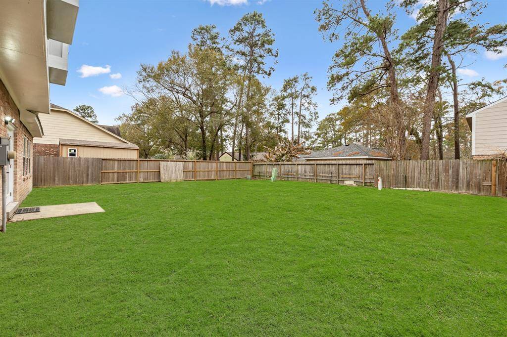 The backyard features a wooden fence for more privacy and security.