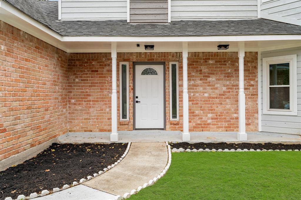 Relax on the cozy covered front porch and enjoy the lush front yard!