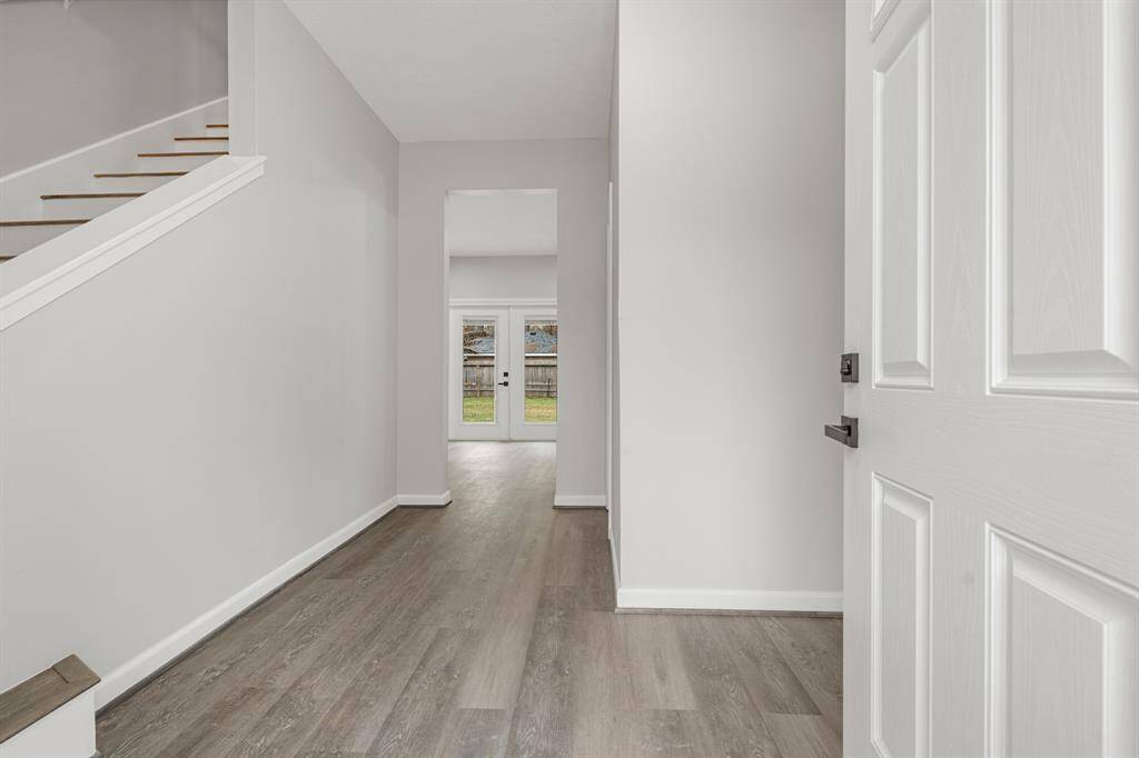 Welcome home! The grand entry into this fantastic home highlights a gorgeous staircase, vinyl plank floors, and high ceilings.