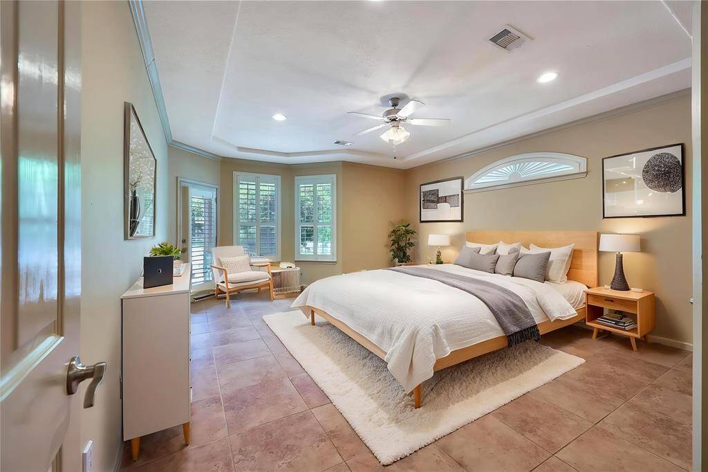 *virtually staged* Primary bedroom with patio access