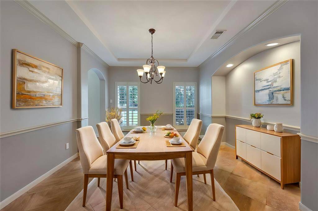 *virtually staged* Formal dining room leads to kitchen with hutch bump out