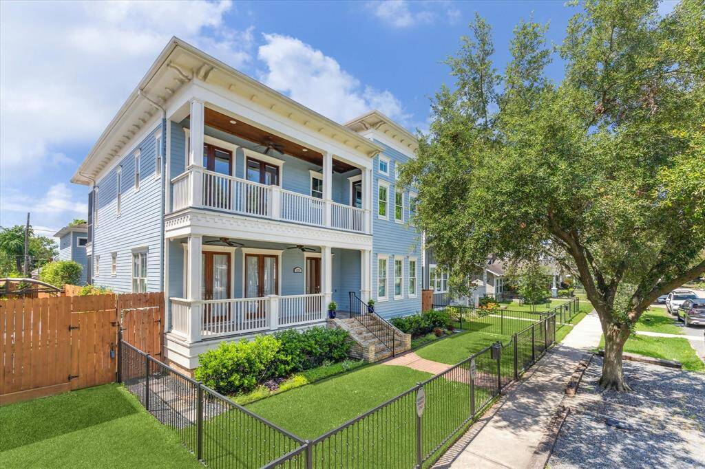 Stunning Houston Heights Curb Appeal: This elegant two-story home showcases classic Southern charm with expansive double verandas, crisp white railings, and a beautifully manicured lawn framed by lush greenery and a wrought-iron fence. The inviting exterior and timeless architecture create an unforgettable first impression in the heart of Houston Heights.