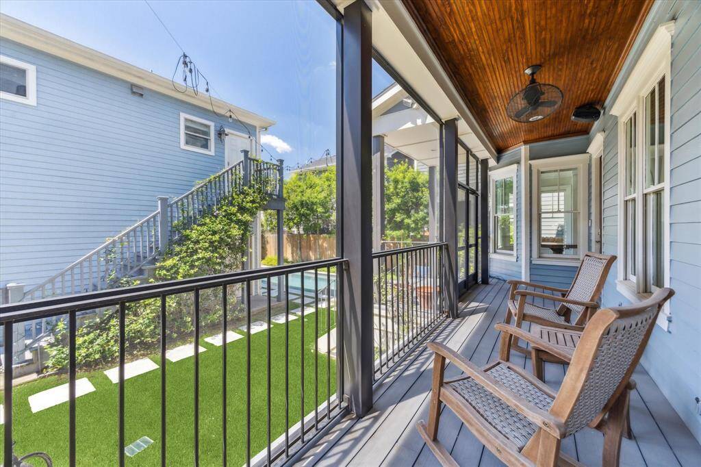 Relaxing Covered Balcony with Backyard Views: This spacious covered balcony provides a perfect outdoor retreat, overlooking the lush backyard and pool area. With comfortable seating, a warm wood ceiling, and a cooling ceiling fan, it’s an ideal spot for morning coffee or evening relaxation.