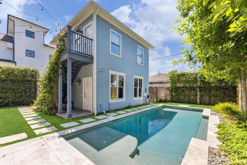 Private Poolside Oasis with Garage Apartment: Enjoy resort-style living with a sleek pool surrounded by lush greenery and modern pavers, all overlooked by a charming garage apartment. Perfect for guests, a home office, or rental income, this versatile space enhances both comfort and convenience.