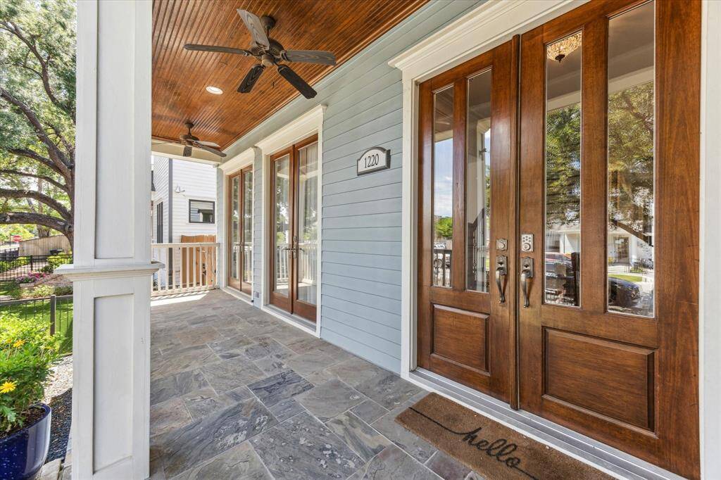 Elegant Southern Welcome: Step onto the expansive front porch with its rich wood-paneled ceiling, twin ceiling fans, and stately double French doors. This inviting entryway exudes warmth and sophistication, perfect for greeting guests or enjoying quiet moments in the heart of Houston Heights.