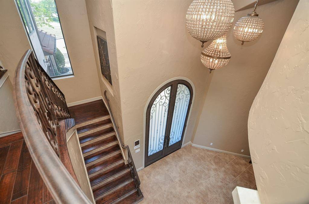 Take a moment to admire the exquisite lighting fixtures, including the stunning chandeliers, which grace this space with their beauty. Their radiance is visible and captivating from both the upper and lower levels, creating a truly enchanting ambiance.